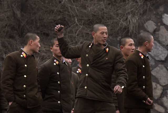 North Korean soldiers practise throwing grenades on the banks of Yalu River in the North Korean town of Sinuiju, opposite the Chinese border city of Dandong, March 6, 2013. (Photo by Jacky Chen/Reuters)