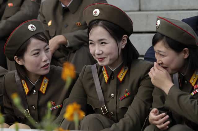 North Korean female soldiers smile before a parade to commemorate the 65th anniversary of the founding of the Workers' Party of Korea in Pyongyang October 10, 2010. (Photo by Petar Kujundzic/Reuters)
