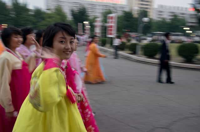 A Korean woman waves after the mass dance, September 2011. (Eric Testroete)
