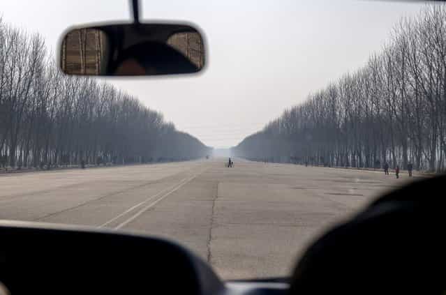 Hero Youth Highway from Pyongyang to Nampo, a city on the west coast of the peninsula, 2012. Many of the highways in North Korea are like this, massive, straight and empty, often going straight through mountains. (Eric Testroete)