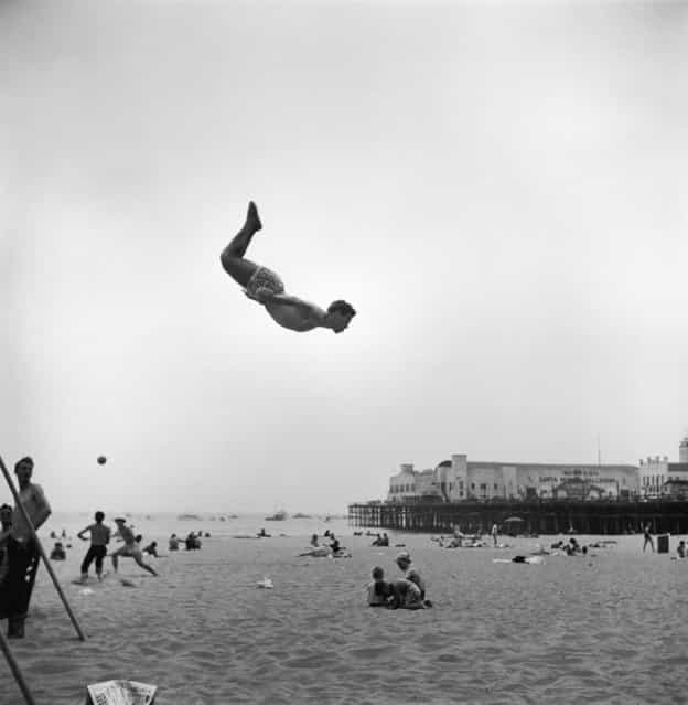 A man flies off a trampoline at Santa Monica Beach, Calif., on July 1, 1948. (Photo by Loomis Dean/Time & Life Pictures)