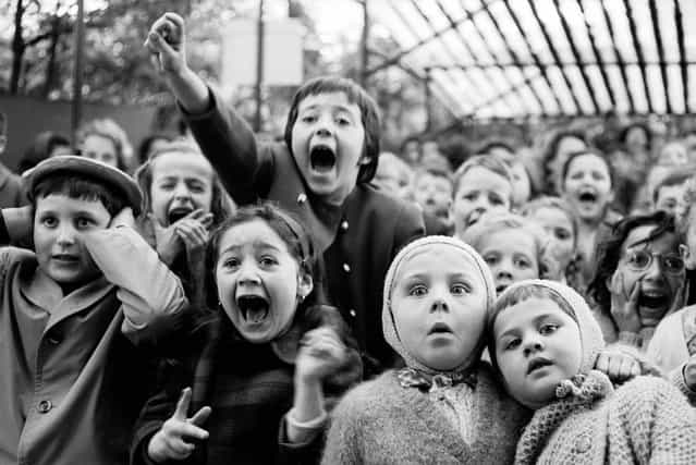 Children watch the story of [Saint George and the Dragon] at an outdoor puppet theater in Paris, in 1963. (Photo by Alfred Eisenstaedt/Time & Life Pictures)
