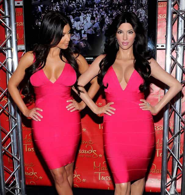 Kim Kardashian, (left) unveils her wax figure replica at Madame Tussauds New York. (Photo by Evan Agostini/Associated Press)