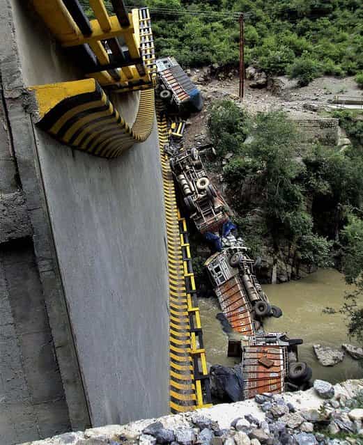 A bridge collapsed on the outskirts of the northern Indian town of Shimla. One person was killed and 2 injured in the accident, according to a news report. (Photo by Associated Press)