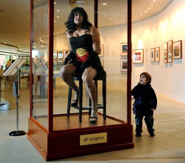 Constantina Bush, an alter-ego of male Aboriginal performer Kamahi King, poses in a museum display case in [Jacky Jacky in the Box] at a preview of a new Aboriginal exhibition titled [20 Years: Bold. Black. Brilliant]. at the Melbourne Museum. The performance art installation challenges audiences to reconsider their perceptions of Indigenous Australia as an anthropological curiosity. (Photo by William West/AFP/Getty Images)