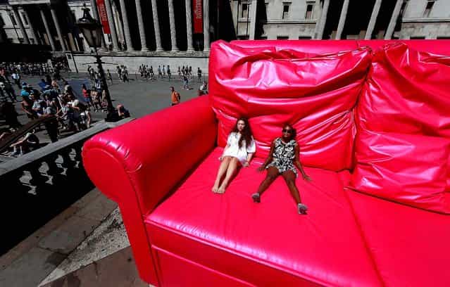 Two girls enjoy the sunshine from a giant pink sofa before the start of the finale of the T-Mobile Big Dance 2010 in Trafalgar Square in London. (Photo by Peter Macdiarmid/Getty Images)