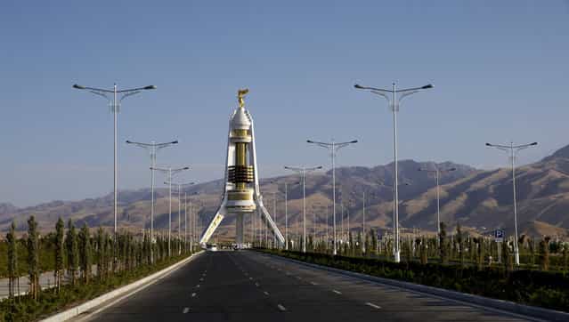 The Monument to Neutrality featuring (and erected by) former president Saparmurat Niyazov. Public buses are routed up an eight-lane boulevard to its base, otherwise it stands mostly deserted. Despite the scarcity of visitors, soldiers at the feet of the structure stand at attention throughout the day. (Photo by Amos Chapple via The Atlantic)