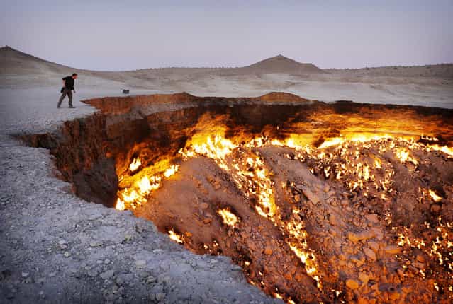 A vivid display of the country's huge gas reserves is the Darvaza gas crater. In the 1970s, Soviet engineers accidentally collapsed this cavern about 260 km north of Ashgabat, while exploring for gas in the Karakum Desert. The escaping methane was lit, intending to quickly burn it off and avoid poisoning nearby villages, but it has continued burning ever since. (Photo by Amos Chapple via The Atlantic)