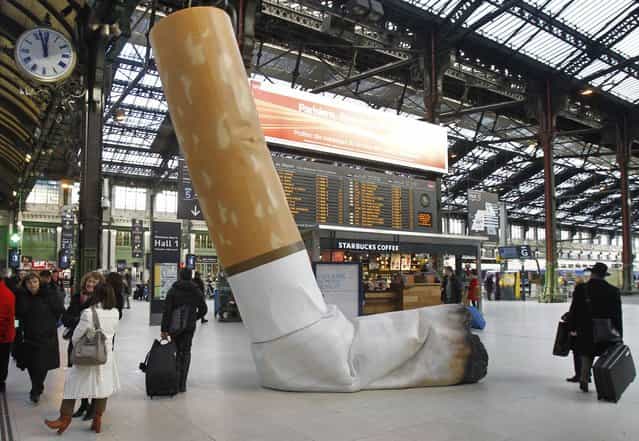 A symbolic cigarette butt is set up inside Gare de Lyon railway station, in Paris, Tuesday December 4, 2012, as part of a publicity campaign against rudeness, by Paris's public transport authority. The possibility of apparent rudeness is being counteracted by an advertising campaign as tourism companies and the Paris transport authority address concerns of tourists during the financial crisis. (Photo by Remy de la Mauviniere/AP Photo)