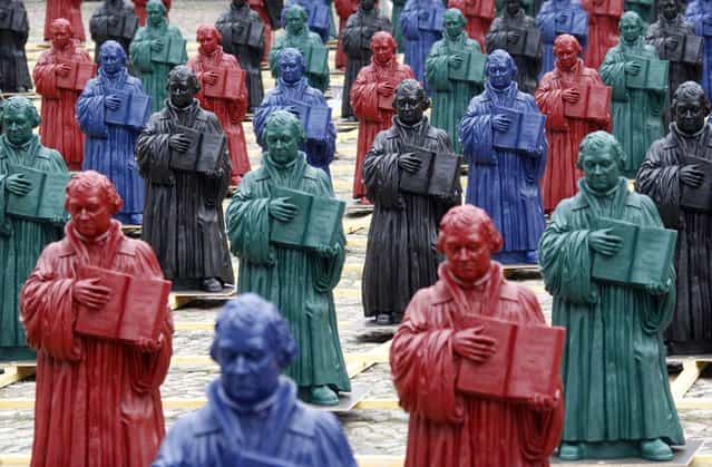 Plastic statuettes of 16th-century Protestant reformer Martin Luther, which are part of the art installation [Martin Luther – I'm standing here] by German artist Ottmar Hoerl, are pictured in the main square in Wittenberg, eastern Germany August 11, 2010. (Photo by Fabrizio Bensch/Reuters)