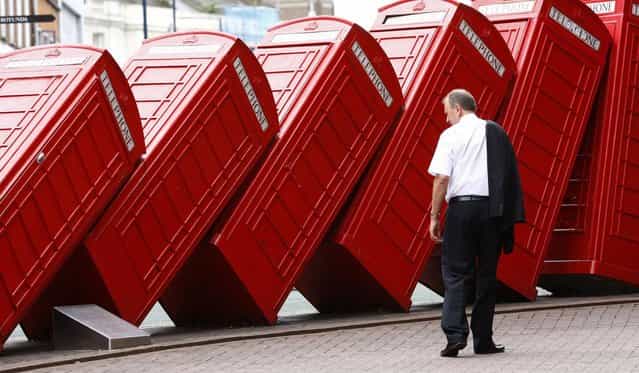A piece by artist David Mach and entitled 'Out of Order' shows a row of traditional English red phone boxes in Kingston, south of London July 15, 2008. (Photo by Eddie Keogh/Reuters)