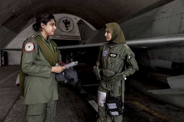 Ayesha Farooq, 26, (R) Pakistan's only female war-ready fighter pilot, talks with avionics engineer Anam Hassan, 24, at Mushaf base in Sargodha, north Pakistan June 7, 2013. (Photo by Zohra Bensemra/Reuters)