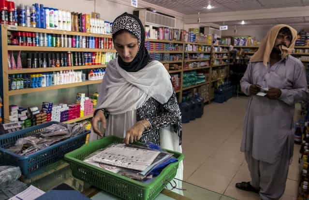 Ayesha Farooq, 26, Pakistan's only female war-ready fighter pilot, shops at the market of Mushaf base in Sargodha, north Pakistan June 7, 2013. (Photo by Zohra Bensemra/Reuters)