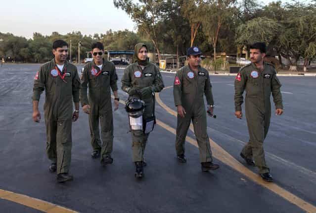 Ayesha Farooq, 26, (C) Pakistan's only female war-ready fighter pilot, walks with Wing Commander of Squadron 20 Nasim Abbas (2nd R) and her colleagues toward a Chinese-made F-7PG fighter jet at Mushaf base in Sargodha, north Pakistan June 6, 2013. (Photo by Zohra Bensemra/Reuters)