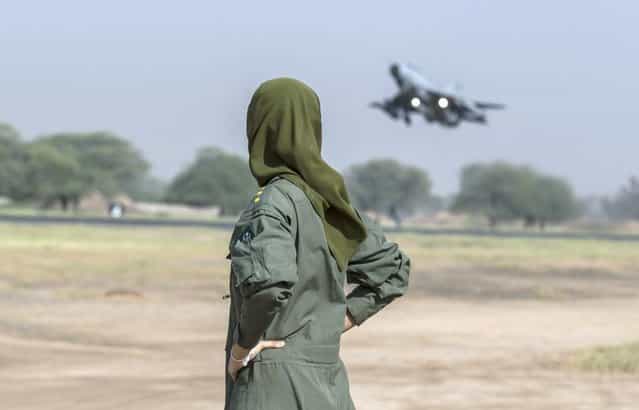 Ayesha Farooq, 26, Pakistan's only female war-ready fighter pilot watches an airforce jet about to take off at Mushaf base in Sargodha, north Pakistan June 7, 2013. (Photo by Zohra Bensemra/Reuters)