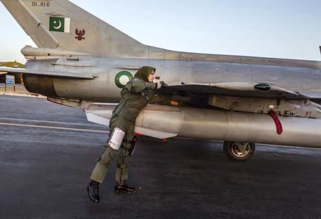 Ayesha Farooq, 26, Pakistan's only female war-ready fighter pilot, performs a pre-flight check on a Chinese-made F-7PG fighter jet at Mushaf base in Sargodha, north Pakistan June 6, 2013. (Photo by Zohra Bensemra/Reuters)