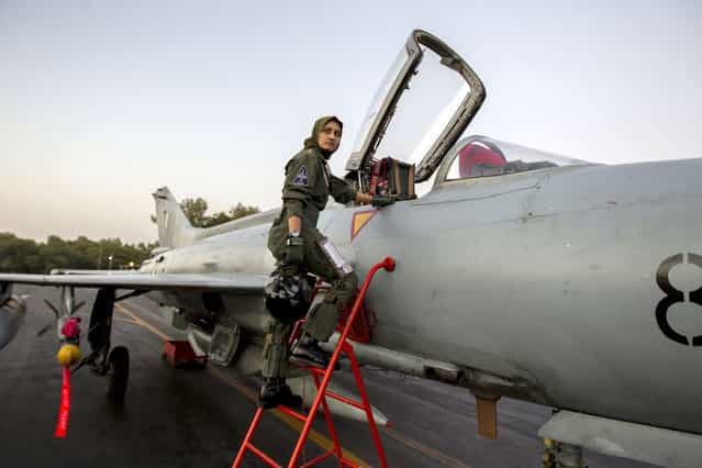 Ayesha Farooq, 26, Pakistan's only female war-ready fighter pilot, climbs up to a Chinese-made F-7PG fighter jet at Mushaf base in Sargodha, north Pakistan June 6, 2013. (Photo by Zohra Bensemra/Reuters)