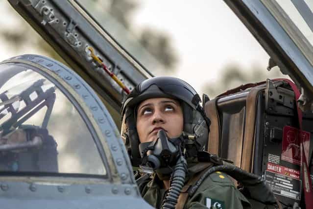 Ayesha Farooq, 26, Pakistan's only female war-ready fighter pilot, looks up as she closes the cockpit of a Chinese-made F-7PG fighter jet at Mushaf base in Sargodha, north Pakistan June 6, 2013. (Photo by Zohra Bensemra/Reuters)