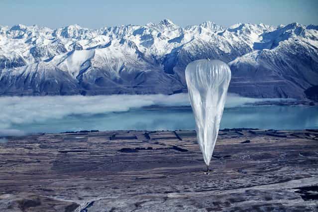 A Google balloon sails through the air with the Southern Alps mountains in the background, in Tekapo, New Zealand. (Photo by Jon Shenk/Associated Press)