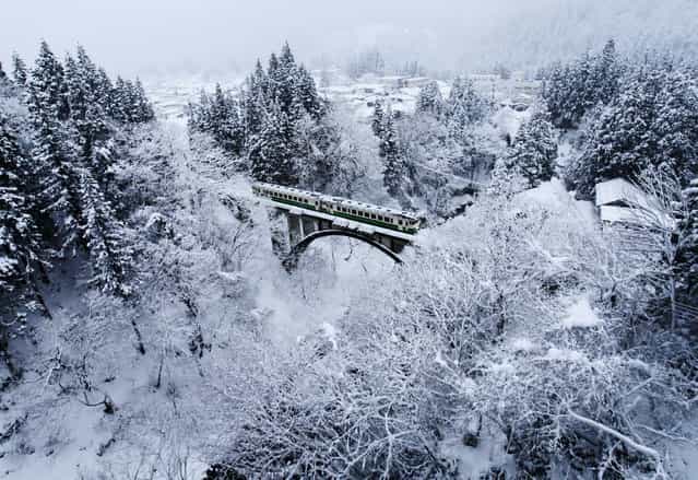 [White village]. Tadami　line has been running the Aizu region of Fukushima Prefecture. Winter of Aizu region is famous as one of the leading heavy snowfall area in Japan. (Photo and caption by Hideyuki Katagiri/National Geographic Traveler Photo Contest)