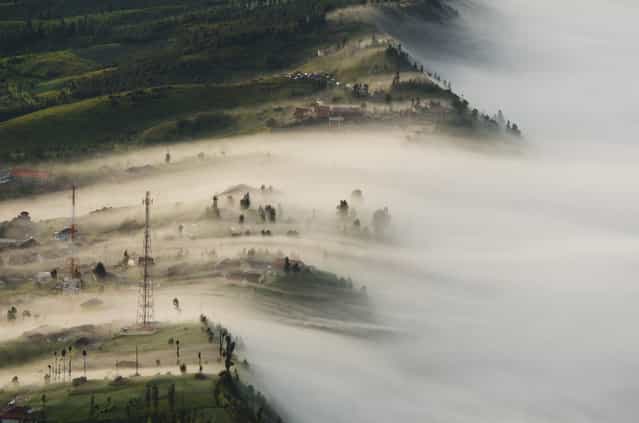 [Overflow]. This photo was shot in a scenic view of Cemoro Lawang which is a very small town north-east of Mount Bromo. The misty tsunami is appearing at every dawn that hit the little settlement which located at the altitude of 2,217 meters above sea level. People living a simple life in this mountaineous town will be enveloped by misty air with a sense of breathtaking and harmony in contrary to an active volcano's temper. Location: Bromo-Tengger-Semeru National Park, East Java, Indonesia. (Photo and caption by Yuan Choong Chin/National Geographic Traveler Photo Contest)