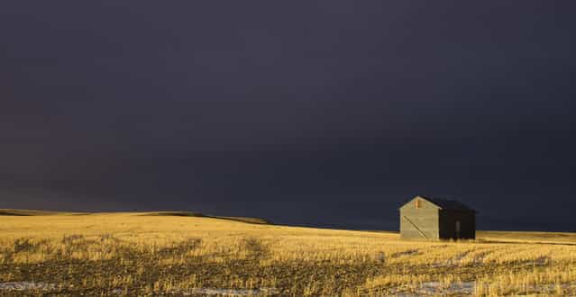 [Troubled Skies]. An impending storm moving in over a beautifully lit field in the evening in Montana, USA. (Photo and caption by James Lam/National Geographic Traveler Photo Contest)