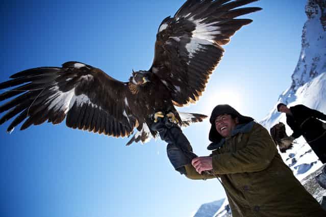 [Kazakh Eagle Hunters]. Eagle Hunting is a Kazakh tradition that dates back 2000 years. Around 350 Kazakh Eagle Hunters are keeping the tradition alive in the Altai Mountains, Mongolia. (Photo and caption by Tariq Sawyer/National Geographic Traveler Photo Contest)