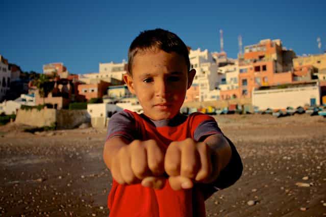 [Left or right?] I was taking some shots on the beach of Taghazout, Morocco, when this little guy came up to me asking in what hand he was holding a coin. After playing along I asked if I could take his picture. (Photo and caption by Thomas Pieters/National Geographic Traveler Photo Contest)