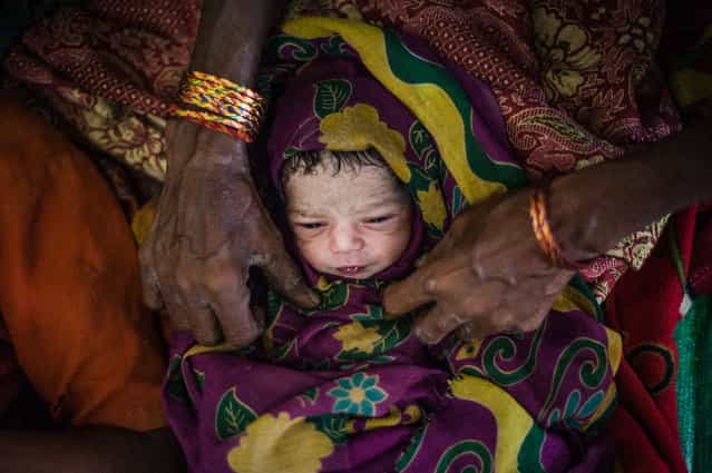 [20 minutes]. Newborn child in after home delivery. Burma 2012. (Photo and caption by Mstyslav Chernov/National Geographic Traveler Photo Contest)