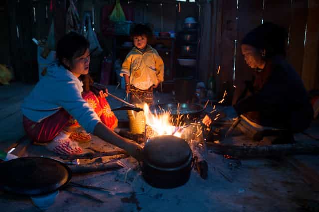 [The life in Pulang]. Pulang women was cooking dinner for the whole family. In Pulang,such an ancient society, women are in charge of all the household duties. Location: Xishuangbanna, Yunnan, China. (Photo and caption by Tianze Jiang/National Geographic Traveler Photo Contest)