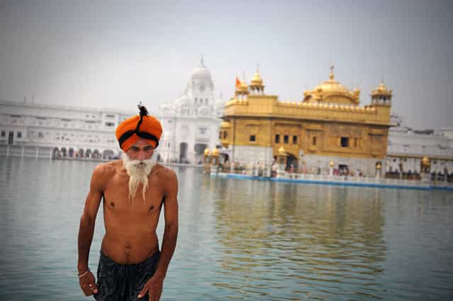 [Singh Is Kinng]. A Sikh man gets out of the water at the Sri Harmandir Sahib, Golden Temple in Amritsar, India. The temple is considered by Sikhs as the holiest shrine of their religion. (Photo by Arif Patani, www.Patani-Photo.com). (Photo and caption by Arif Patani/National Geographic Traveler Photo Contest)