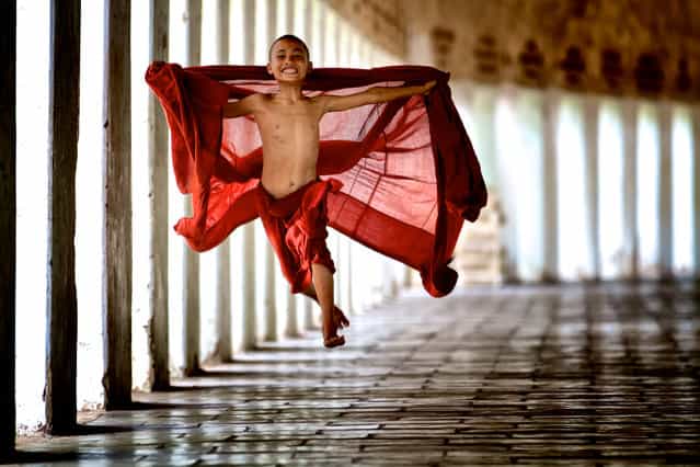 [Flying Monk]. Young monks begin their service very early in life in their studies in the monastery. This monk was young and energetic and decided to [fly] in his exuberance for life. Location: Mandalay, Myanmar. (Photo and caption by Bonnie Stewart/National Geographic Traveler Photo Contest)