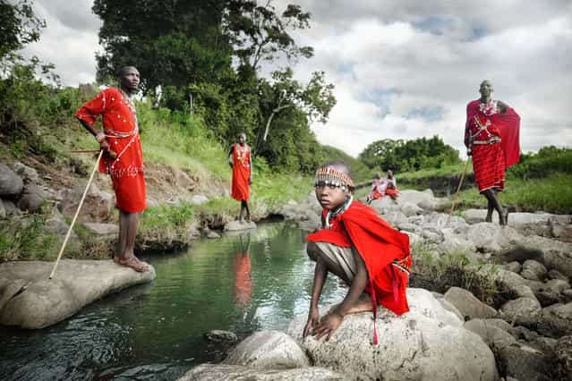 [One Day a Masai Warrior]. These Masai tribes people live in the wilderness of Kenya and still uphold most of their traditional values and customs. The colour red is worn to represent power, and accessories and body ornaments are be worn to reflect their identity and status in society. Traditionally, a Masai boy would only become a Masai warrior after he went out on his own and killed a lion, as a rite of passage. Location: Masai Mara, Kenya. (Photo and caption by David Lazar/National Geographic Traveler Photo Contest)