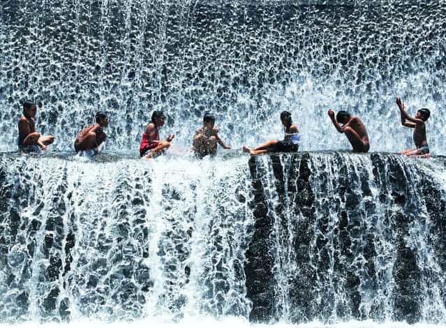 [Another Day in Paradise]. Balinese kids showering in a waterfall at Tukad Unda, Bali, Indonesia. (Photo and caption by Michael Ivan Rusli/National Geographic Traveler Photo Contest)