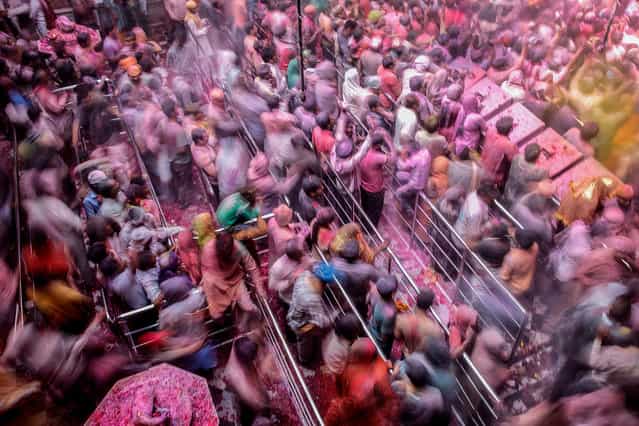 [Melting Pot]. Holi celebration at Banke Bihari, the Hindu temple dedicated to Lord Krishna and located in the holy city of Vrindavan: it's late morning in the temple and the crowd slowly begins to flow outside the temple, while many others continue to celebrate the event. (Photo and caption by Massimiliano De Santis/National Geographic Traveler Photo Contest)