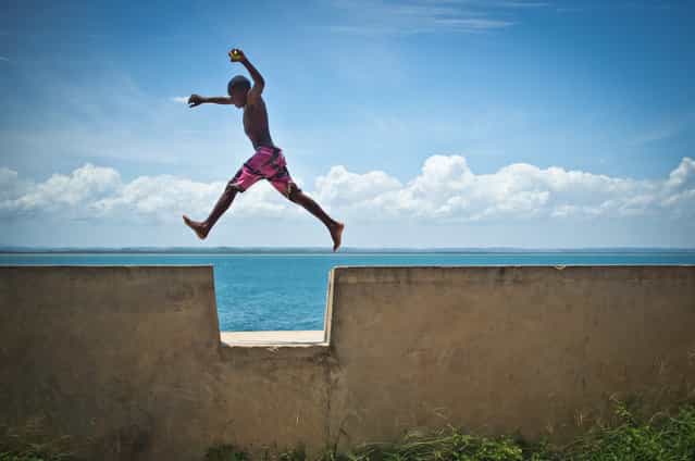 [Child Soul – Bahia Brazil]. This boy was playing jumping every gap of the 500 meters fortress wall. Every jump was unique and full of joy and lightness. Location: Morro de Sao Paulo, Bahia, Brazil. (Photo and caption by Mauricio Pisani/National Geographic Traveler Photo Contest)