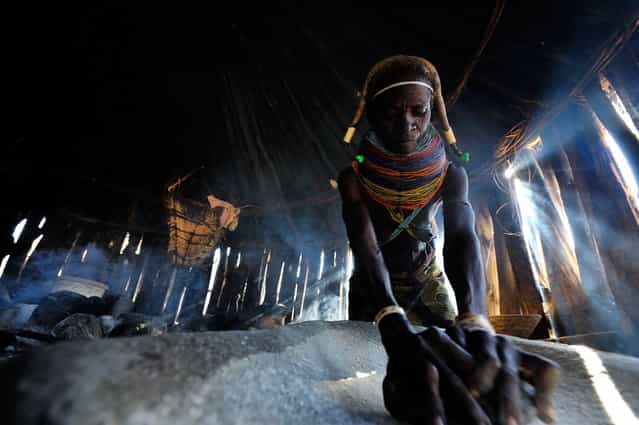 [Making dinner]. This photo was made in a small muila village in South-Angola, Africa, 2012 June. The spontaneous moment was captured inside of the hut of the lady. (Photo and caption by Gergely Lantai-Csont/National Geographic Traveler Photo Contest)