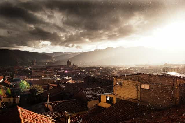 [Cusco Sunset]. The view from our hotel room in the San Blas district of Cusco. This area of town overlooked the rest of the city and gave us a breathtaking view as the sun & rain mixed one evening. Location: Cusco, Peru. (Photo and caption by Blake Burton/National Geographic Traveler Photo Contest)