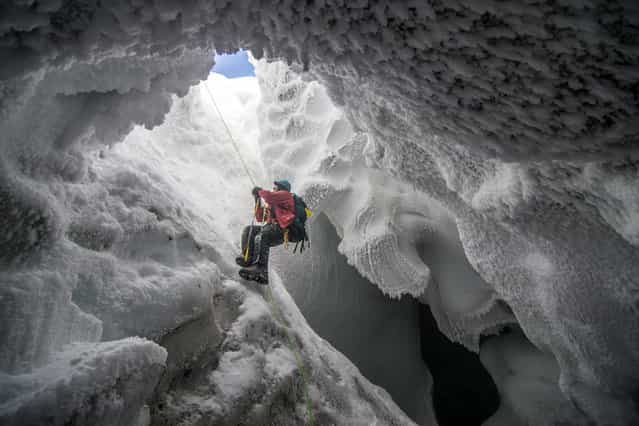 [Mount Erebus Ice Cave]. A scientist climbs out of an ice cave formed by volcanic vents near the summit of Mt. Erebus, Antarctica. (Photo and caption by Alasdair Turner/National Geographic Traveler Photo Contest)