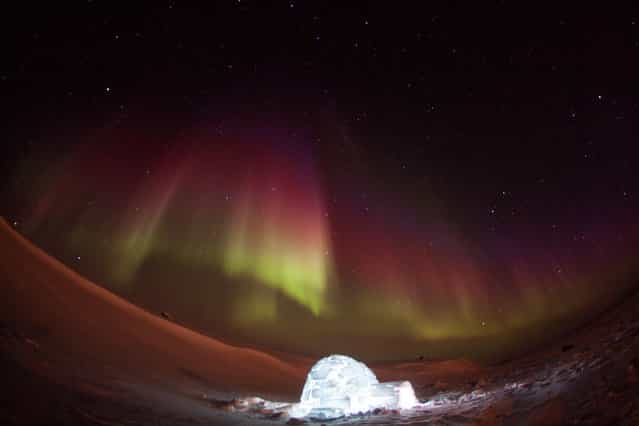 [Igloo]. Flying for an exploration camp in the Canadian arctic, my helicopter engineer and I had some time to build an igloo. –30C was cold taking photos at night but well worth it! Location: 200 Miles NE of Yellowknife NT, Canada. (Photo and caption by Nathan Shute/National Geographic Traveler Photo Contest)