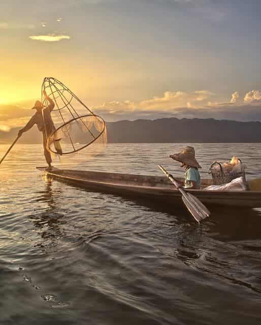 [Fishing]. A father and daughter with a fish in the net at sunset on Inle Lake, Myanmar. (Photo and caption by Cynthia MacDonald/National Geographic Traveler Photo Contest)