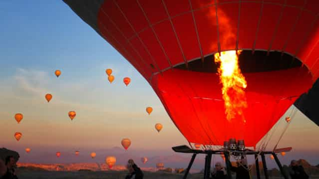 [Ready to Fly?] A combination of an early morning sun,coupled with cool wind and a breathtaking bird eye's view of Cappadocia, Turkey urges one to abandon the safety of the ground to seek for a serenity up in the air that is impossible to duplicate with 2 feet planted. (Photo and caption by Isaac Cheong/National Geographic Traveler Photo Contest)