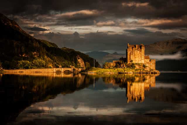 [Elean Donan Castle]. Many photos of this castle are made, but this one has a last shine of the sun on rocks and stone, separating the castle from the landscape. (Photo and caption by Frank Heumann/National Geographic Traveler Photo Contest)