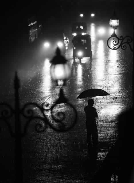 [In the middle of the pouring rain]. The picture has been taken in Kandy in Sri Lanka. We found a shelter just before the monsoon rain and watched the streets. (Photo and caption by Bartlomiej Mielnik/National Geographic Traveler Photo Contest)