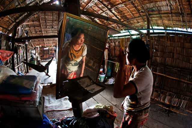 [My Old Home]. The interior home of one of the outback villages in the outskirts of Siem Reap, Cambodia is as simple as it can be, devoid of much luxuries and necessities, as can be seen in the home of this Cambodia lady making herself up before she starts her day. (Photo and caption by Nick Ng Yeow Kee/National Geographic Traveler Photo Contest)