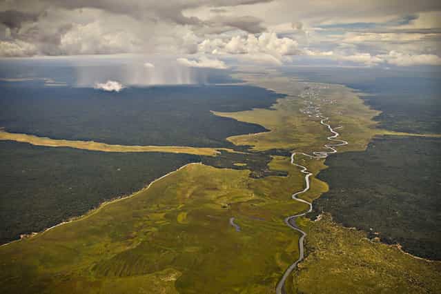 [Rains On The Plains Of Angola]. One can't help but to wonder what this river must have looked like eons ago. Now only a trickle of its former self but still a wondrous in its beauty. Location: North Eastern Angola, Africa. (Photo and caption by Rob McIntyre/National Geographic Traveler Photo Contest)