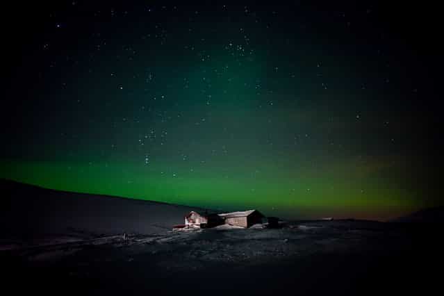 [Viewers' Choice Winner: Huset]. A lonely cabin is illuminated under the Northern Lights in Finnmark, Norway. (Photo and caption by Michelle Schantz/National Geographic Traveler Photo Contest)