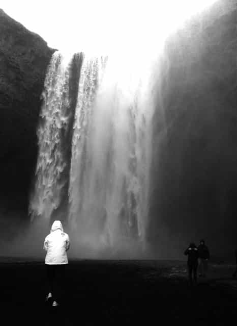 [Skogafoss Waterfall]. The Skogafoss is named after the river crashing down the cliffs. Skogar is Icelandic for [wood] and it is therefore assumed there were once trees in that area. I took this shot as my tourmates admired the majestic beauty of the waterfall while all of us tried to brave the intense cold. (Photo and caption by Cher Gonzalez/National Geographic Traveler Photo Contest)