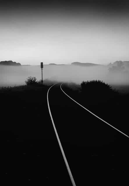[Destination Unknown]. Following a lonely road in my new village during the early hours, I came upon a dead end. However just as I was about to depart I noticed the railroad tracks and how the fog swallowed them and it got me to thinking. Where was the rail leading to? How many people would be on the train very soon heading to... destination unknown. Location: Rehweiler, Germany. (Photo and caption by Mark Seawell/National Geographic Traveler Photo Contest)