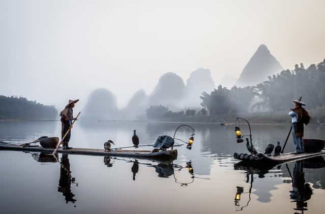[Fishermans in the fog]. Cormorans fisherman on the Li river, Yangshuo – China. (Photo and caption by Philippe Cap/National Geographic Traveler Photo Contest)